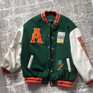 Green and White Varsity Jacket with Orange Accents